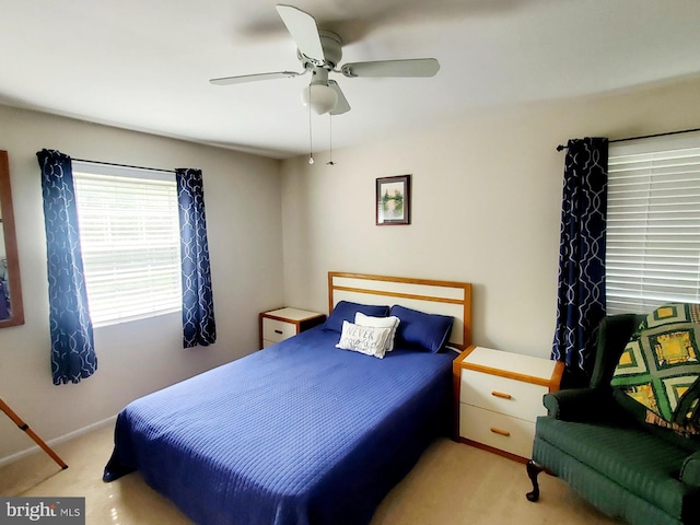 bedroom featuring ceiling fan and light carpet