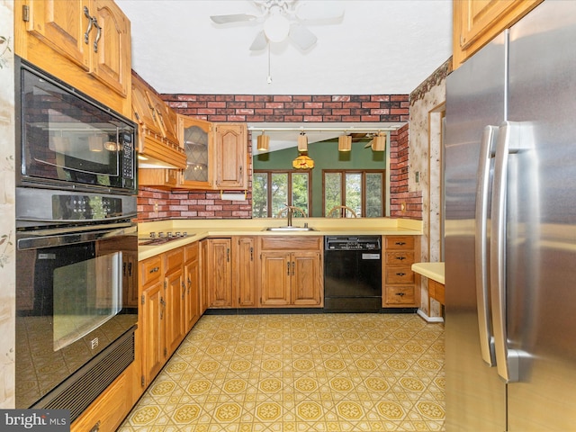 kitchen with light countertops, a sink, ceiling fan, and black appliances