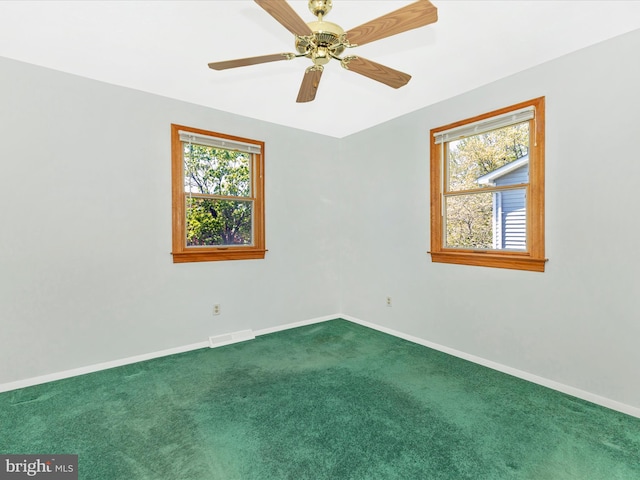 spare room featuring baseboards, carpet, a ceiling fan, and visible vents