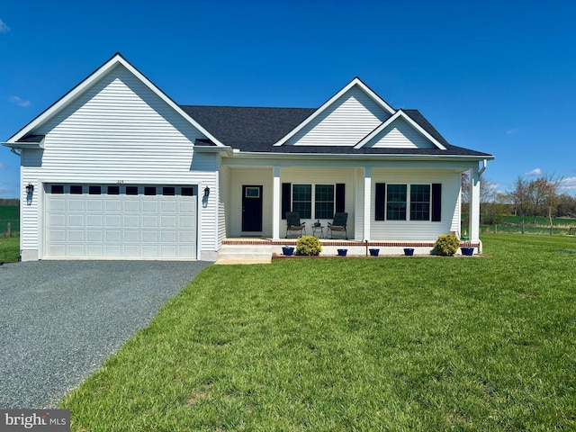 view of front facade with a porch, driveway, a front yard, and a garage