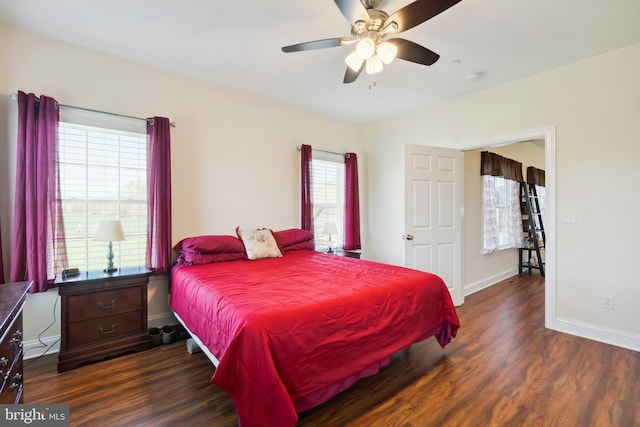 bedroom featuring dark wood-type flooring, baseboards, and a ceiling fan