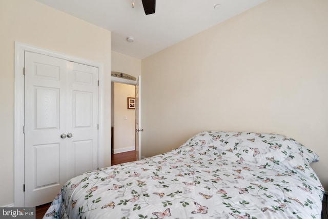 bedroom featuring a closet, ceiling fan, and wood finished floors