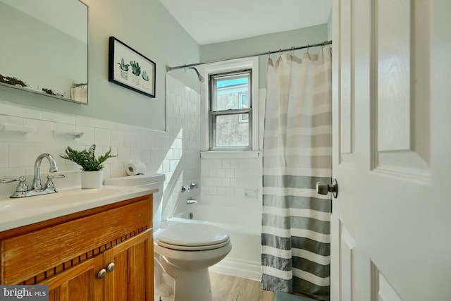 full bathroom featuring shower / tub combo with curtain, wood finished floors, vanity, and toilet