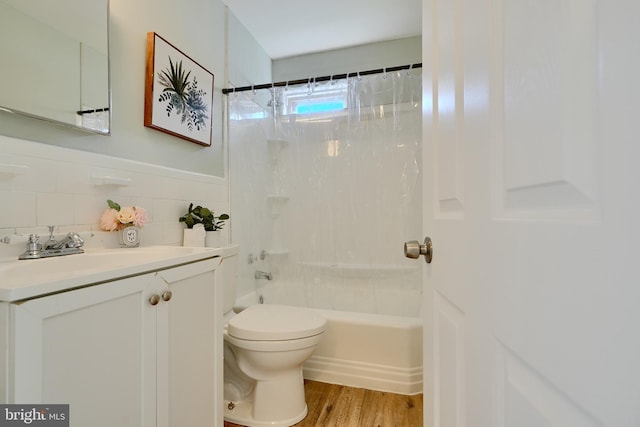 full bath with wood finished floors, vanity, tile walls, shower / tub combo, and toilet