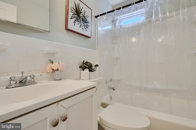bathroom featuring shower / bath combo, toilet, vanity, and tile walls