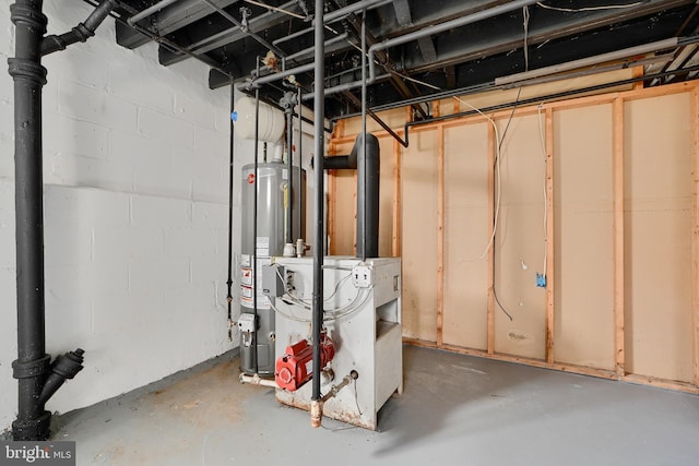unfinished basement featuring water heater and concrete block wall