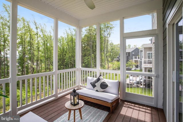 sunroom / solarium with a ceiling fan and a healthy amount of sunlight