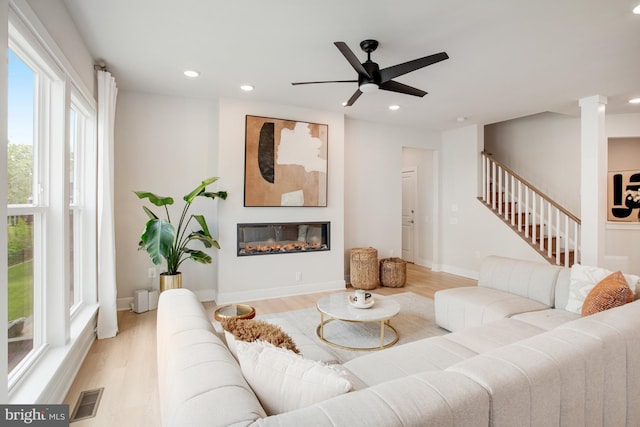 living area featuring recessed lighting, light wood-style floors, stairs, and visible vents