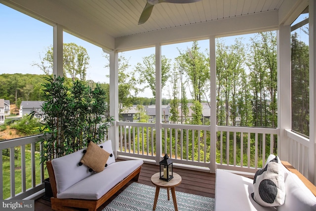 sunroom featuring a ceiling fan