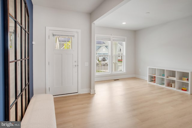 entryway featuring baseboards, recessed lighting, wood finished floors, and visible vents