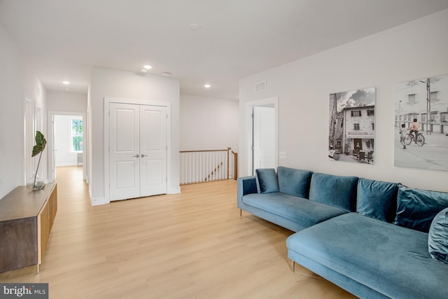 living room featuring recessed lighting, visible vents, and light wood-style flooring