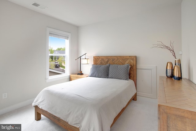 bedroom featuring visible vents, carpet flooring, and baseboards
