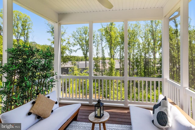 sunroom / solarium with a ceiling fan and a wealth of natural light