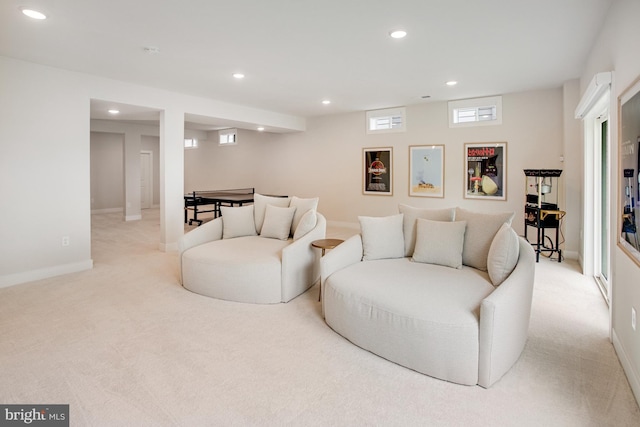 living area featuring recessed lighting, baseboards, and light colored carpet