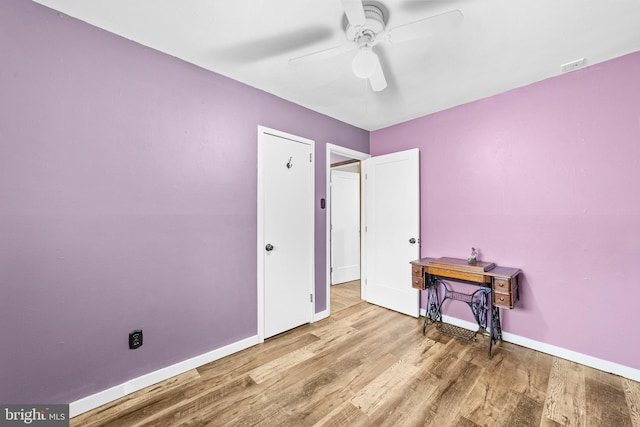 bedroom featuring baseboards, a ceiling fan, wood finished floors, and visible vents