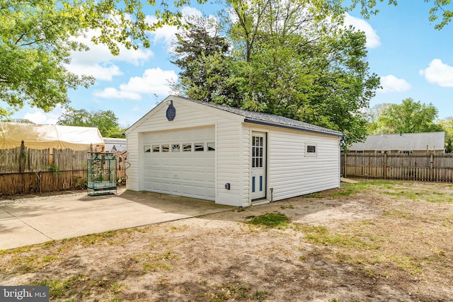 detached garage featuring fence