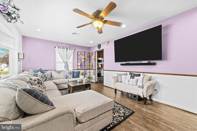 living room featuring visible vents, wood finished floors, recessed lighting, a wainscoted wall, and a ceiling fan