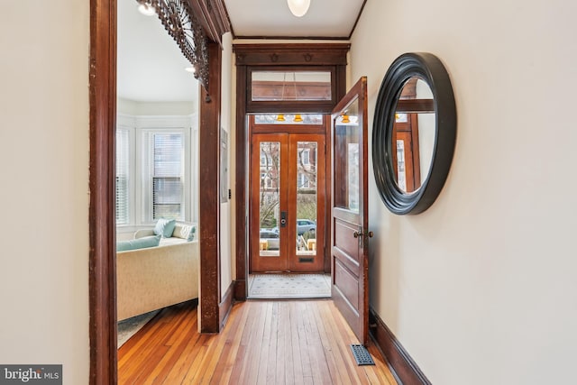 1231 Girard St NW, Washington, DC 20009 - foyer entrance featuring light wood finished floors, french doors, baseboards, and visible vents