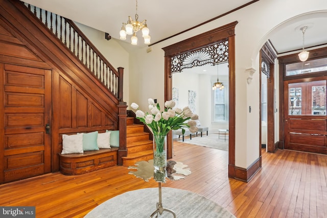 1231 Girard St NW, Washington, DC 20009 - foyer entrance featuring wood-type flooring, stairway, an inviting chandelier, and a healthy amount of sunlight