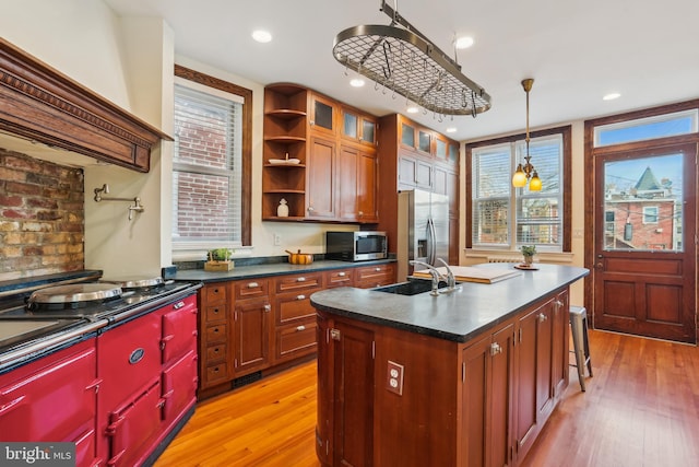 1231 Girard St NW, Washington, DC 20009 - kitchen with open shelves, a sink, appliances with stainless steel finishes, dark countertops, and light wood-style floors
