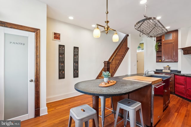 1231 Girard St NW, Washington, DC 20009 - kitchen featuring open shelves, dark countertops, an island with sink, recessed lighting, and wood finished floors