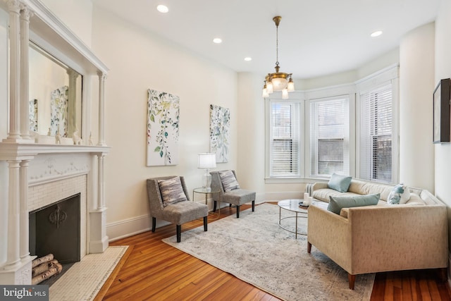 1231 Girard St NW, Washington, DC 20009 - living area featuring a chandelier, wood-type flooring, and baseboards