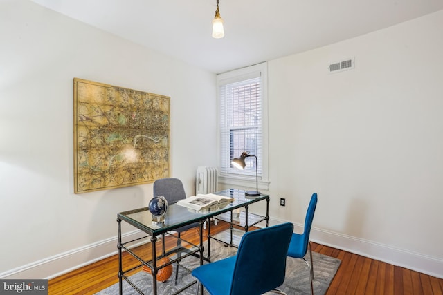 1231 Girard St NW, Washington, DC 20009 - home office featuring visible vents, baseboards, radiator, and hardwood / wood-style floors