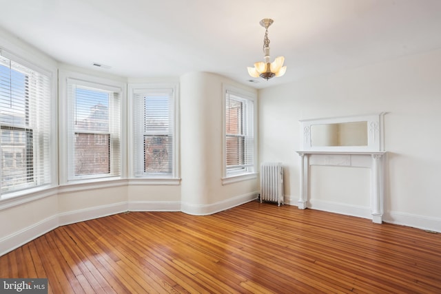 1231 Girard St NW, Washington, DC 20009 - unfurnished dining area featuring visible vents, baseboards, an inviting chandelier, light wood-style floors, and radiator heating unit