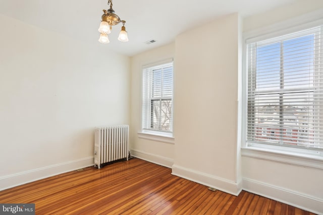 1231 Girard St NW, Washington, DC 20009 - unfurnished room with visible vents, baseboards, hardwood / wood-style floors, and radiator