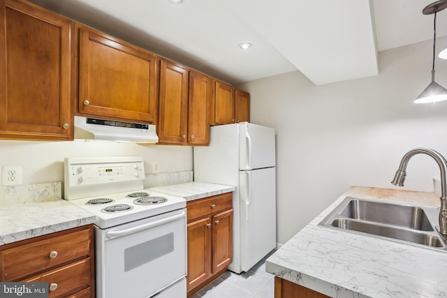 1231 Girard St NW, Washington, DC 20009 - kitchen with white appliances, under cabinet range hood, light countertops, a sink, and brown cabinets