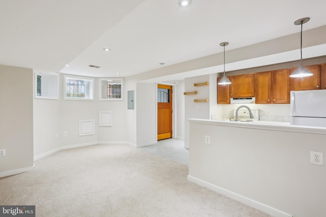 1231 Girard St NW, Washington, DC 20009 - kitchen featuring baseboards, exhaust hood, freestanding refrigerator, brown cabinets, and light colored carpet