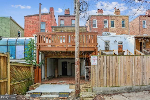 1231 Girard St NW, Washington, DC 20009 - back of property with brick siding, fence, and a wooden deck