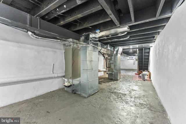 unfinished basement featuring heating unit