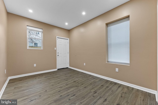 interior space featuring recessed lighting, baseboards, and wood finished floors