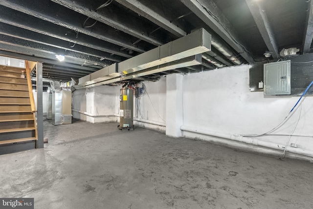 unfinished basement with heating unit, stairs, electric panel, and water heater