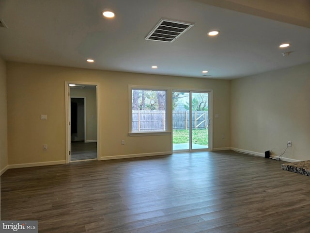 spare room with dark wood-style flooring, baseboards, visible vents, and recessed lighting