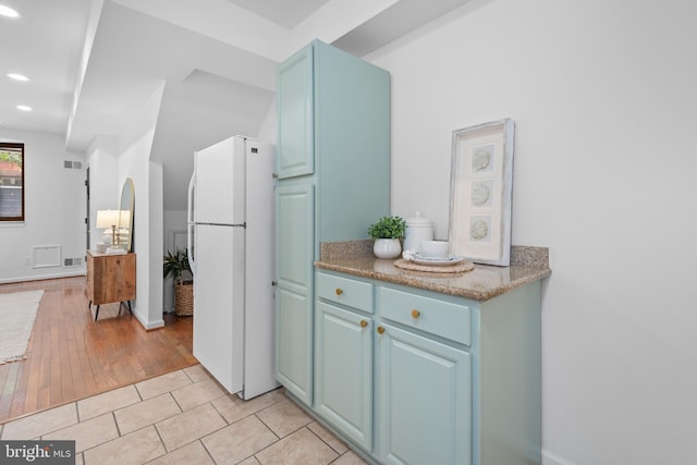 1773 Swann St NW, Washington, DC 20009 - kitchen featuring freestanding refrigerator, recessed lighting, blue cabinetry, and light tile patterned floors