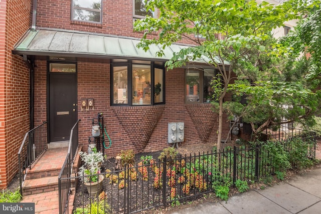 1773 Swann St NW, Washington, DC 20009 - view of front of house with a standing seam roof, brick siding, and a metal roof