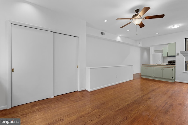1773 Swann St NW, Washington, DC 20009 - unfurnished living room featuring a ceiling fan, wood finished floors, and recessed lighting