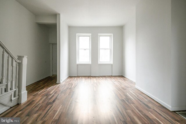 3923 Brown St, Philadelphia, PA 19104 - unfurnished living room featuring wood finished floors, baseboards, visible vents, and stairs