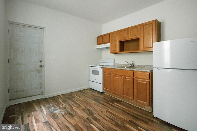 3923 Brown St, Philadelphia, PA 19104 - kitchen with a sink, dark wood-style flooring, light countertops, white appliances, and under cabinet range hood