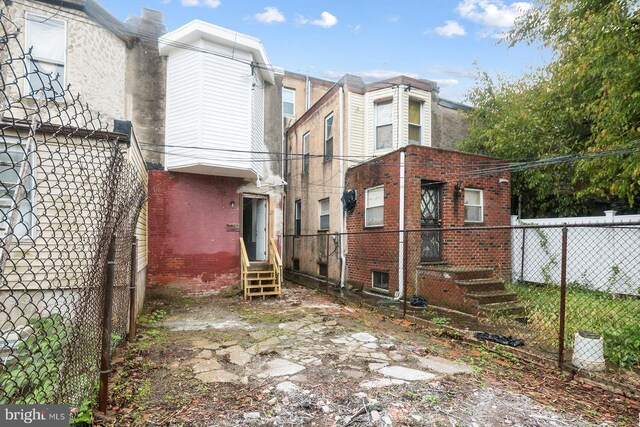 3923 Brown St, Philadelphia, PA 19104 - view of property exterior with entry steps, fence, brick siding, and a chimney