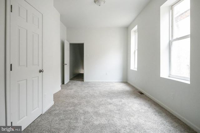3923 Brown St, Philadelphia, PA 19104 - unfurnished bedroom with baseboards, multiple windows, and carpet