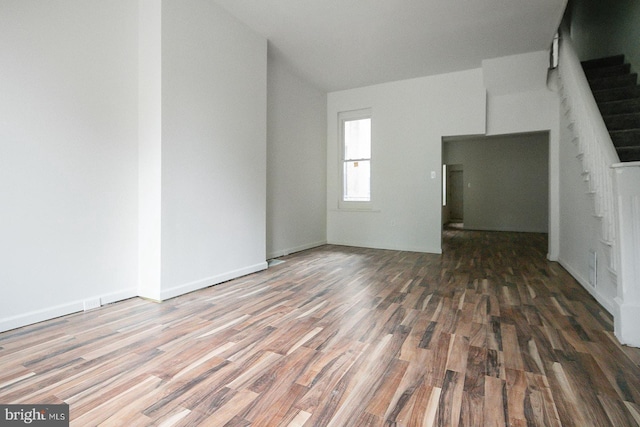 3923 Brown St, Philadelphia, PA 19104 - unfurnished living room with wood finished floors, vaulted ceiling, and stairs