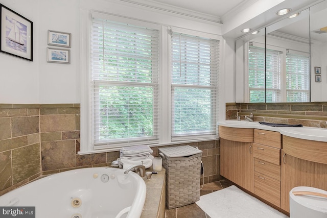 full bathroom featuring crown molding, a jetted tub, healthy amount of natural light, tile walls, and double vanity