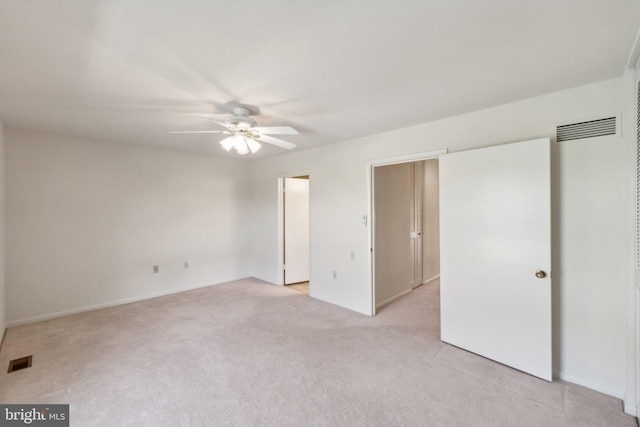 unfurnished bedroom featuring light colored carpet, a ceiling fan, and visible vents