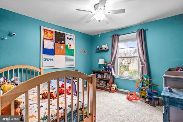 carpeted bedroom with baseboards and a ceiling fan