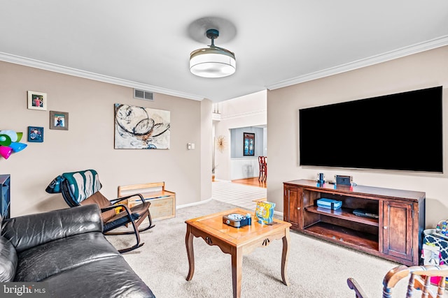 carpeted living area featuring visible vents, baseboards, and ornamental molding