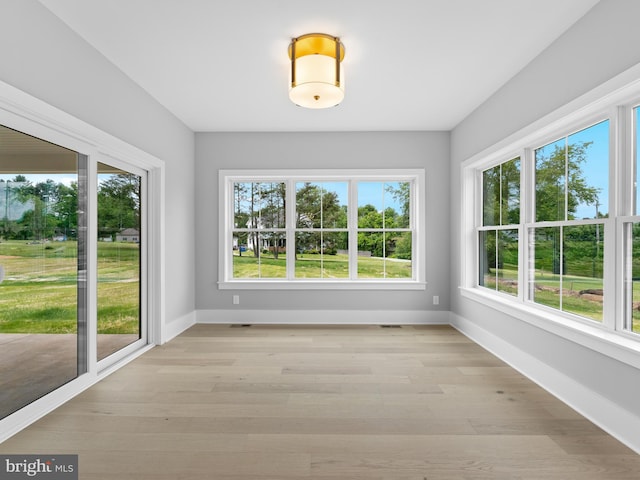 unfurnished sunroom with a wealth of natural light and visible vents