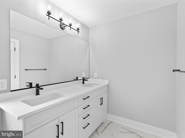full bathroom featuring a sink, baseboards, double vanity, and marble finish floor